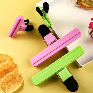 Durable plastic food bag sealing clips in pink and green for snack bag preservation