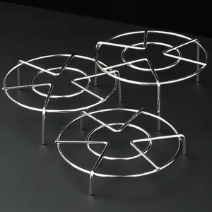 Set of three stainless steel round steaming racks with different heights for cooking