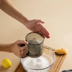 Hand-held semi-automatic flour sifter with fine stainless steel mesh for professional baking
