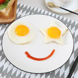 Creative breakfast set with star and round fried eggs using stainless steel molds