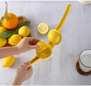 Efficient manual dual-layer aluminum lemon squeezer being used to press fresh citrus fruit