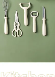Detailed layout of minimalist cream kitchen tool set featuring a whisk and scissors