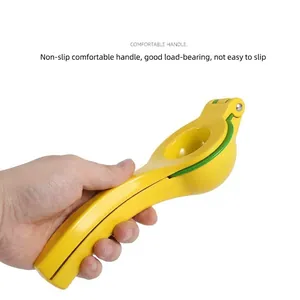 Professional manual dual-layer lemon squeezer made of yellow aluminum alloy held by a hand