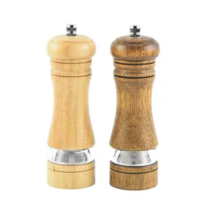 Two manual oak pepper grinders with ceramic core and acrylic window in light and dark wood