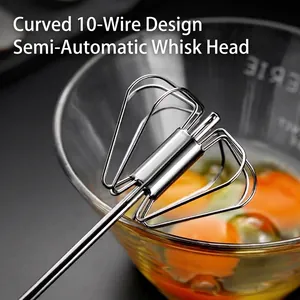 Semi-automatic stainless steel egg whisk shown whisking fresh eggs in a glass bowl.