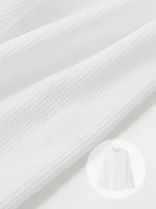 Detailed macro view of white waffle knit fabric texture on men's long sleeve Polo shirt