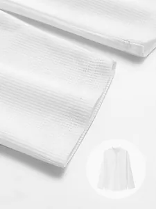 Close-up macro view showing the textured white waffle knit fabric of men's long sleeve Polo shirt