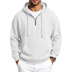 Close-up view of the waffle knit texture and half-zip design on a white men's hoodie.