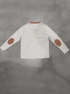 Back view of a white waffle-knit Henley shirt with brown elbow patches