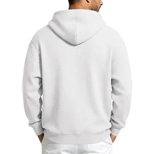 Detailed back view of a white men's waffle knit hoodie showing the textured fabric detail