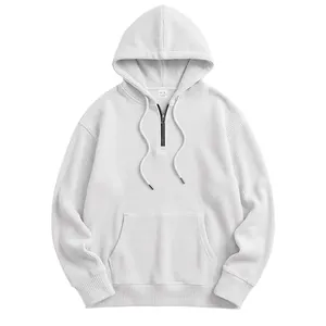 Men's white waffle knit hoodie detail showing half-zip design and front kangaroo pocket