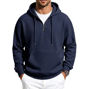 Detail view of men's navy blue waffle knit hoodie with half-zip and kangaroo pocket