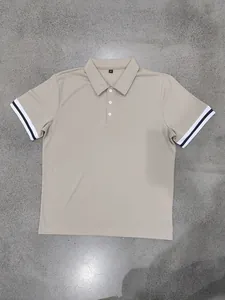 Detailed view of a tan polo shirt featuring striped cuffs and a three-button placket.