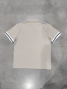 Detailed back view of a khaki men's polo shirt with stylish black and white tipped cuffs