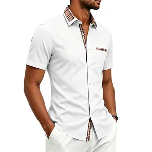 Close-up of men's white short-sleeve shirt featuring classic plaid trim on collar and pocket
