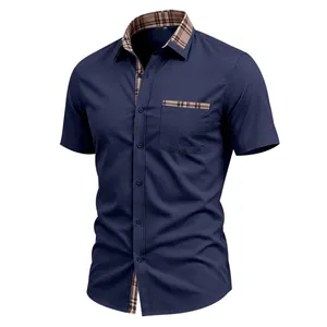 Detail of navy short sleeve shirt featuring plaid contrast collar and chest pocket trim