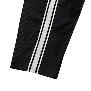 Close-up detail showing the striped side texture of black corduroy leisure sport pants