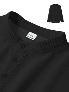 Close-up of black waffle-knit shirt collar with size M label and buttons detail