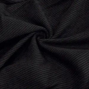 Macro shot of black thin striped corduroy fabric texture for sport casual trousers.