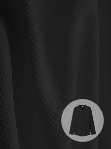 High-definition macro detail of black waffle-knit fabric on men's long-sleeve henley shirt