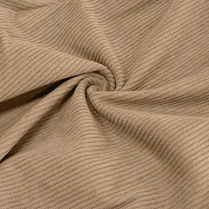 Close-up detail of tan striped corduroy fabric texture for lightweight casual pants.