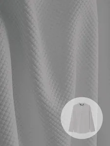 Close-up detail of gray waffle-knit fabric texture with a long-sleeve Henley shirt preview