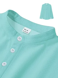 Close-up of mint green waffle knit polo shirt showing collar and buttons texture