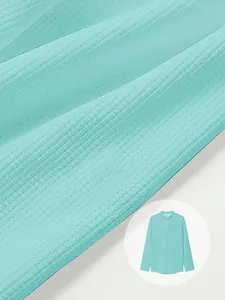 Detail of breathable waffle knit texture on mint green long sleeve Henley shirt