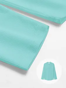 Close-up detail of light blue waffle knit fabric and sleeve cuff on men's polo shirt