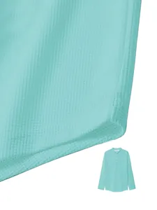 Macro view of the mint green waffle knit fabric on a men's long-sleeve polo shirt