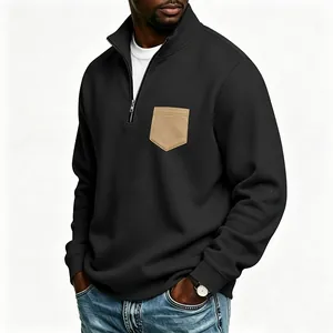 Detailed view of a black men's half-zip sweatshirt with a contrast khaki chest pocket
