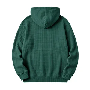 Detailed back view of a dark green waffle knit men's hooded sweatshirt in a loose fit