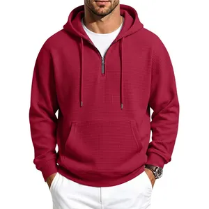 Men's waffle-knit half-zip hoodie in burgundy, featuring a front kangaroo pocket and drawstring hood.