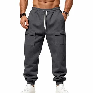 Detailed view of grey cargo sweatpants with drawstring waist and snap pockets.