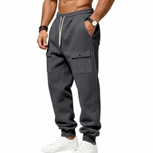 Close-up of men's dark gray fleece cargo sweatpants with snap pockets and drawstring waist