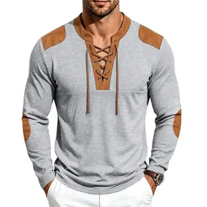 Close-up of men's waffle knit henley shirt with lace-up neck and shoulder patches.