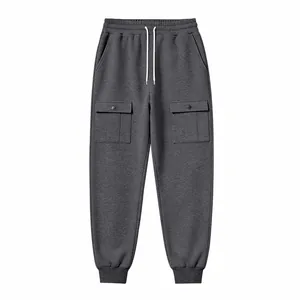 Detail view of men's dark grey cargo joggers with large buttoned side pockets.