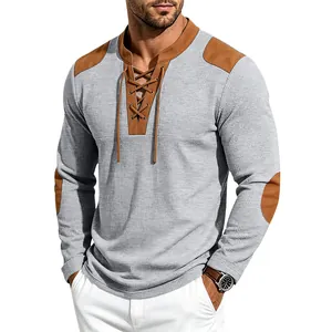Detailed view of a men's gray waffle knit Henley shirt with brown faux leather patches