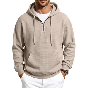 Men's beige waffle knit half-zip hoodie with drawstring hood and kangaroo pocket.