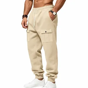 Detailed view of beige men's fleece cargo joggers featuring large snap button pockets.