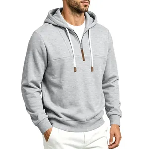 Dettaglio felpa con cappuccio grigia da uomo con mezza zip e coulisse bianche regolabili.