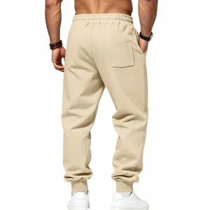 Back view of men's beige fleece joggers featuring tapered cuffs and a functional rear pocket.