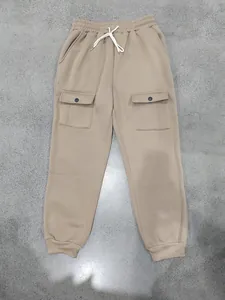 Detailed view of men's khaki cargo sweatpants with drawstring waist and snap pockets.