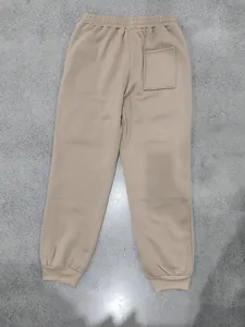 Rear view of men's beige fleece-lined joggers showing back pocket and ribbed cuffs.