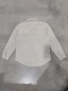 Detailed back view of a men's breathable beige linen long-sleeve shirt with curved hem.
