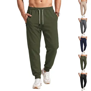 Men's olive sports joggers with elastic drawstring waist and side zipper pockets.