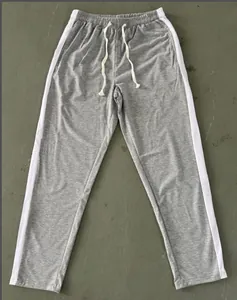 Grey men's casual sports sweatpants featuring white side stripes and elastic drawstring waist
