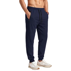 Full view of men's navy blue joggers with drawstring waist and zippered side pockets