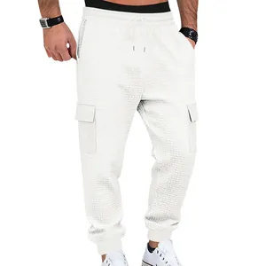 Detail of white waffle knit cargo joggers for men with drawstring waist and pockets