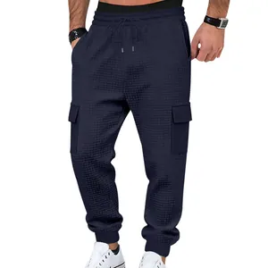 Macro detail of men's navy waffle knit cargo joggers featuring pockets and texture